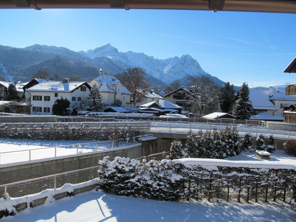 A snow-covered town with buildings and a mountain in the background.