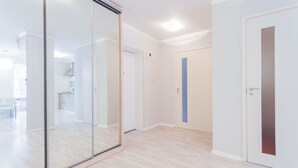 A modern interior with a glass partition, wooden flooring, and white walls. - Newly renovated spacious perfectly located at Baseina str. (Kyiv)