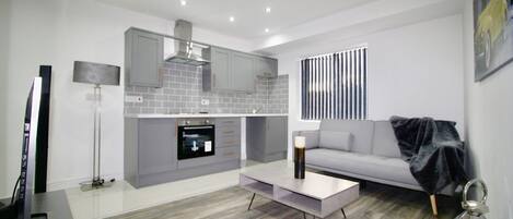 Apartment, 1 Bedroom | Living room | Flat-screen TV