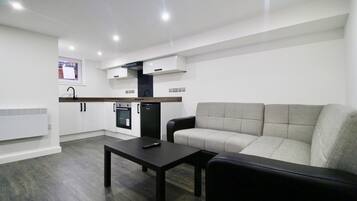 Apartment, 1 Bedroom | Living room | 43-inch flat-screen TV with satellite channels, TV