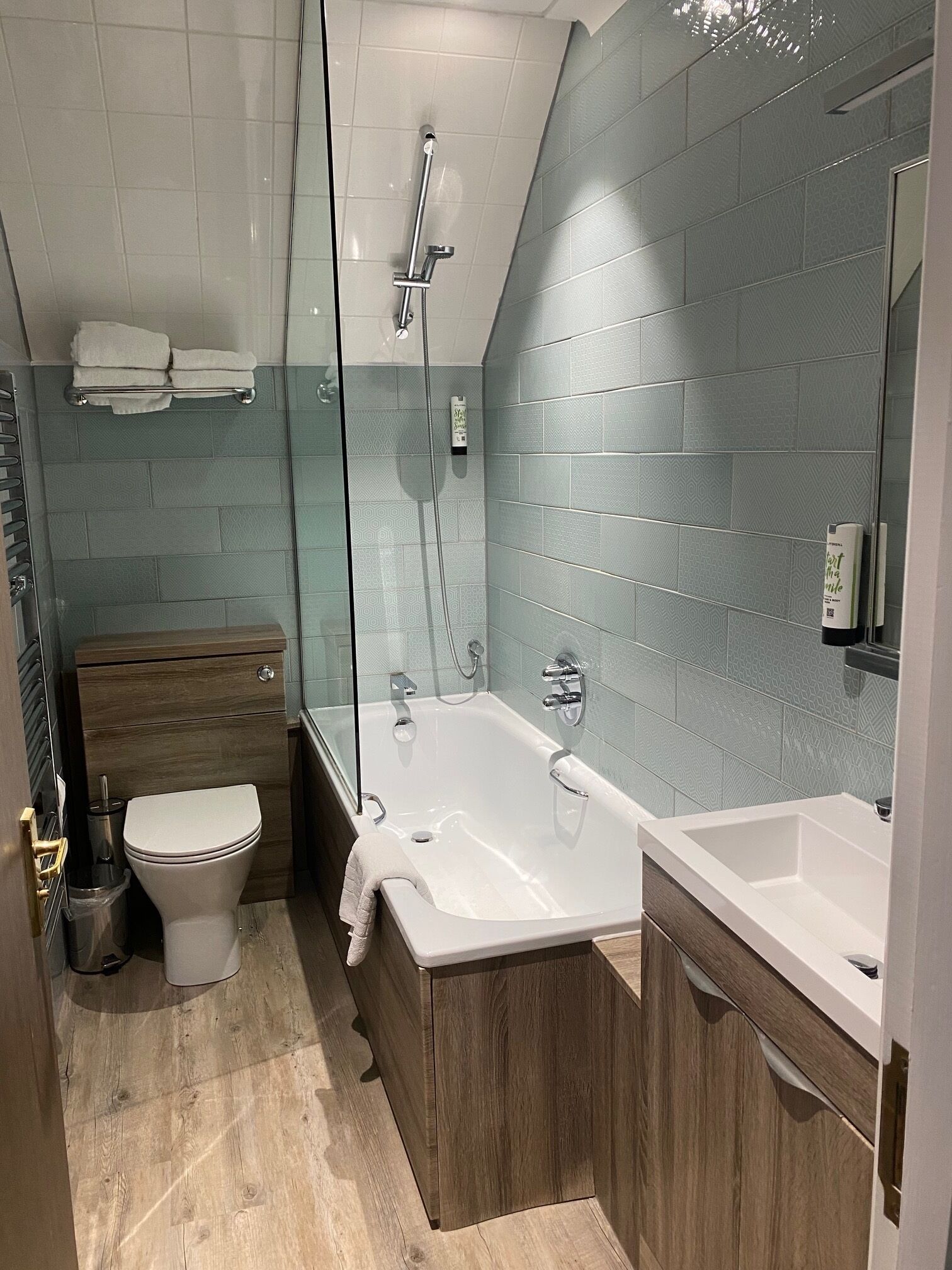 A modern bathroom with a shower, toilet, and bathtub.