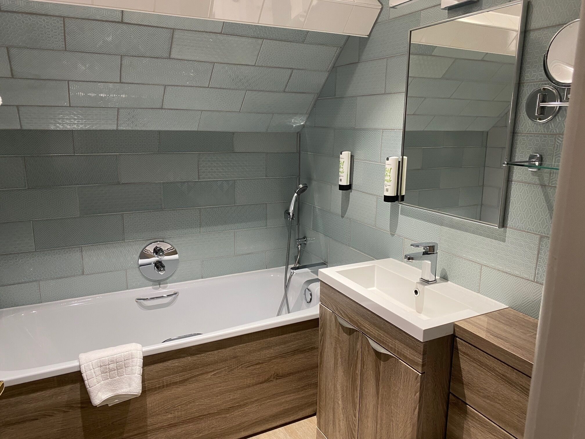 Un baño moderno con una bañera independiente, un tocador con espejo y una zona de ducha.