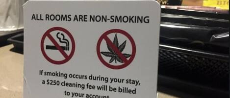 A non-smoking sign with a $250 cleaning fee warning.