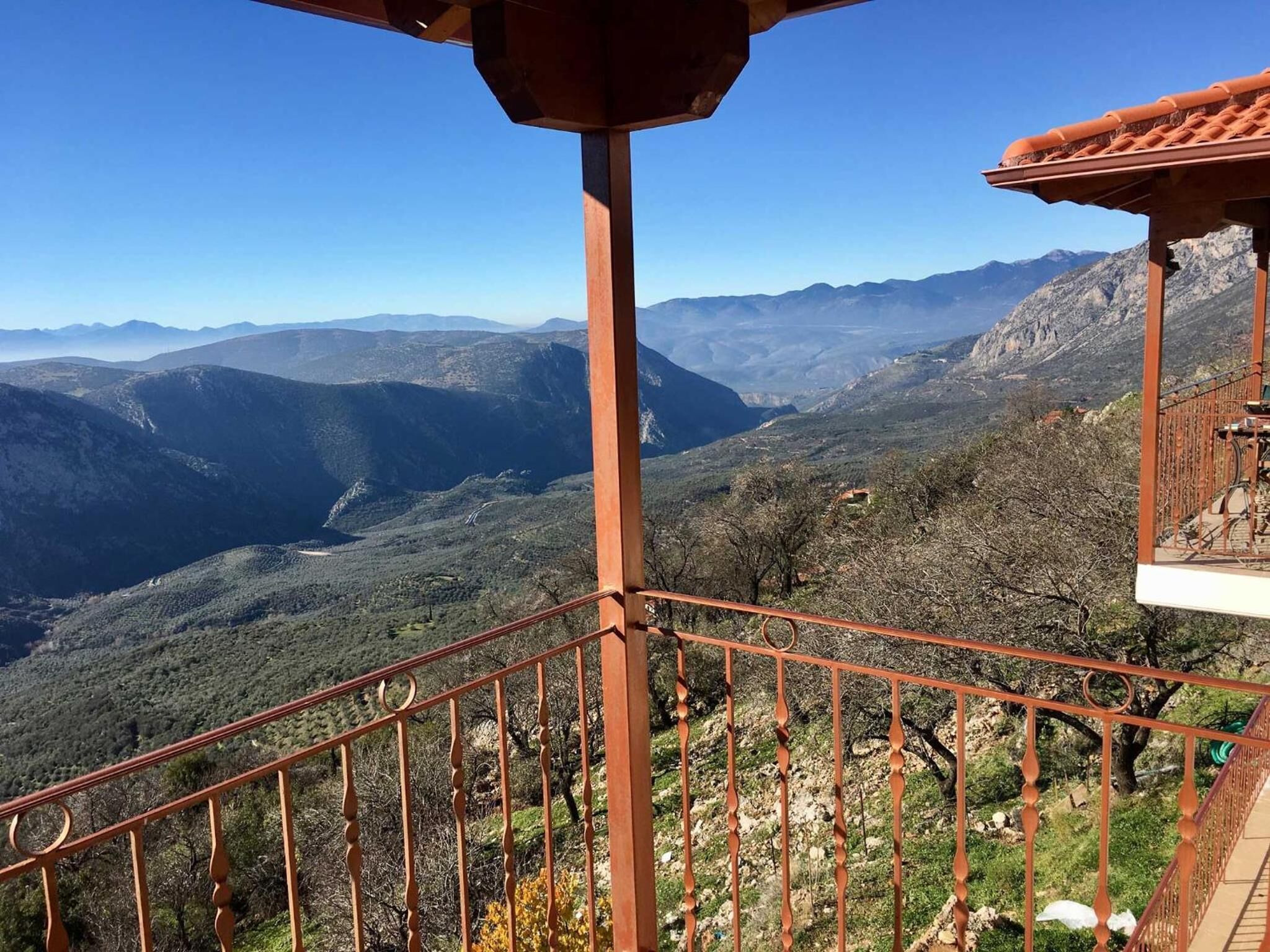 A balcony with a view of mountainous terrain.