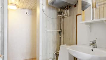 A bathroom with a toilet, sink, and shower.