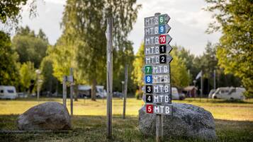 A directional signpost with multiple trail markers.