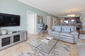 Relax in this stylish living room with a flat-screen TV, comfortable sofa, and convenient console table.