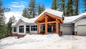 A large, two-story house with a covered porch and a garage. - Smiths Ferry Cabin by Cabarton & Snowmobile Trails (Smiths Ferry)