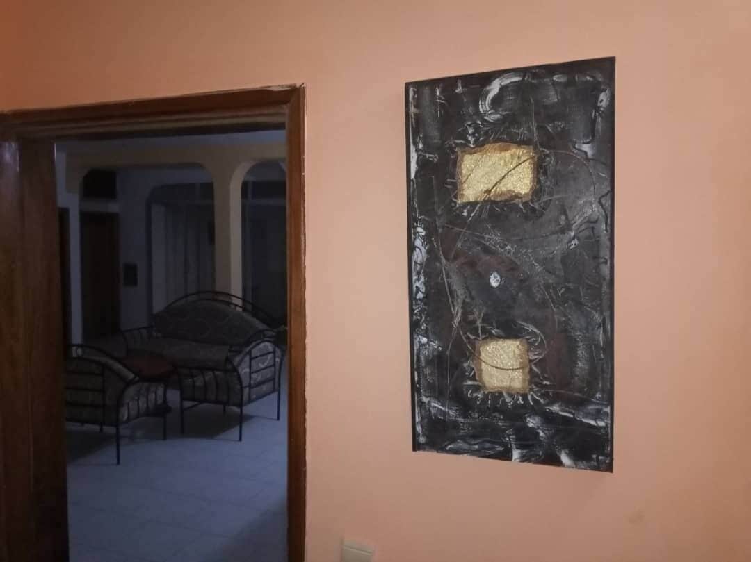 Una habitación con una cama y un cuadro en la pared.