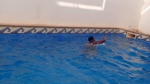 A swimming pool with a tiled edge and a person swimming. - Eden Beach Saint-Louis (St. Louis)