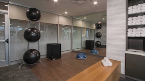 A modern office space with a reception desk, exercise balls, and a wall-mounted shelf with towels. - Fairfield Inn & Suites Duncan (Duncan)