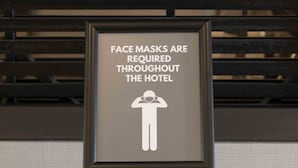 A sign stating that face masks are required throughout the hotel. - Holiday Inn Express Boston Logan Airport - Revere by IHG (Revere)