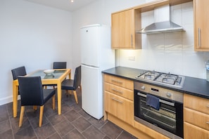 Enjoy cooking in this well-equipped kitchen with a gas stove, oven, and refrigerator.