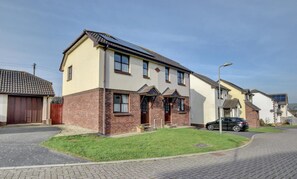 A two-story residential building with a brick facade, a tiled roof, and a small front yard. - 2 Bed in Croyde (oc-sscape) (Croyde)