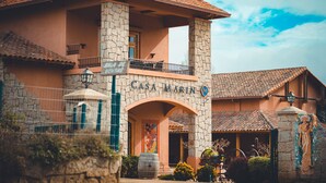 A two-story building with a stone facade, a balcony, and a sign that reads "CASA MARIN". - Villa Miramar at Casa Marin Vineyards (Cartagena)