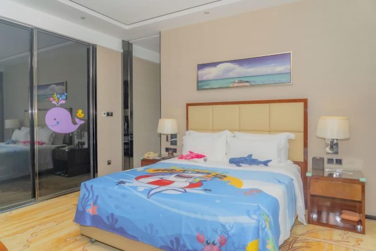 A hotel room with a bed, a nightstand, a painting, and a sliding glass door.