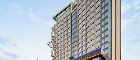 A high-rise hotel with multiple floors, large windows, and a modern architectural design.