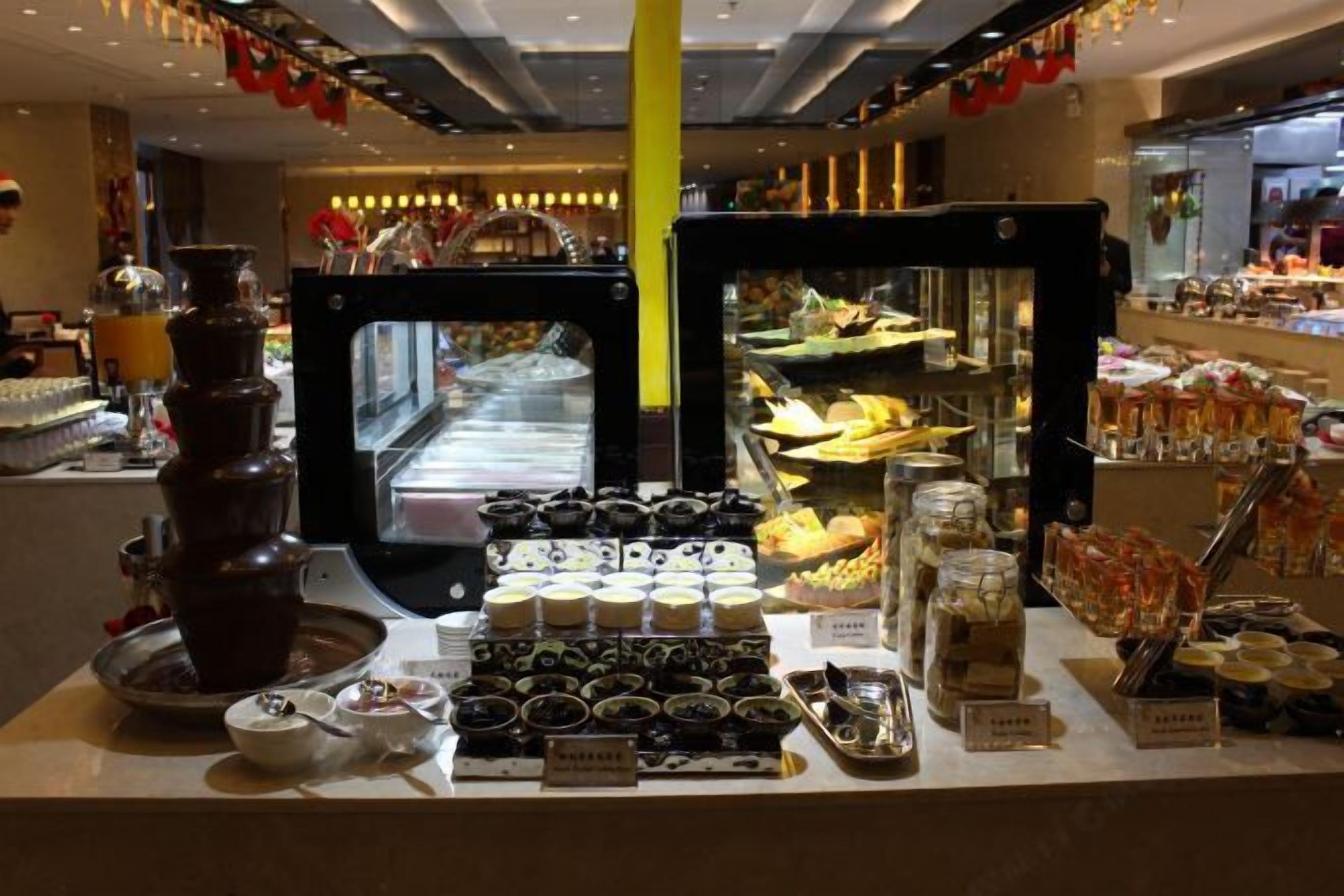 A buffet area with various food items and a chocolate fountain.