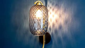 A wall-mounted light fixture with a textured glass cover and a curved design.