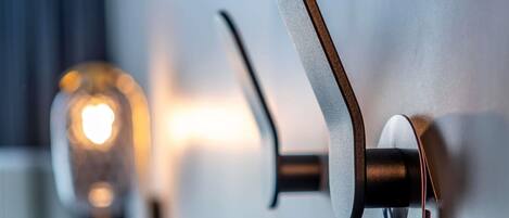 A modern door handle with a metallic finish and a round, textured grip.