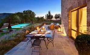 An outdoor dining area with a table set for a meal, surrounded by chairs, and overlooking a swimming pool. - VILLA FELICE - Three Bedroom Villa, Sleeps 6 (Perugia)