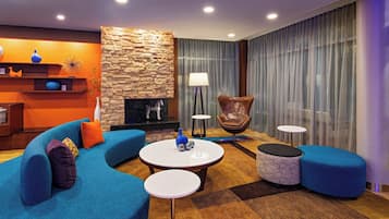 Relax in style with a comfortable sofa, armchair, and fireplace.