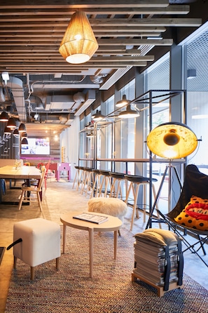 A modern office space with a large table, multiple chairs, and a unique lamp.