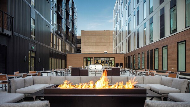 An outdoor seating area with a fire feature, tables, and chairs. - Element by Marriott Iowa City (Iowa City)
