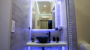 A modern bathroom with a built-in sink, a mirror, and a ventilation system. - Luxury guesthouse nature (Nafplio)