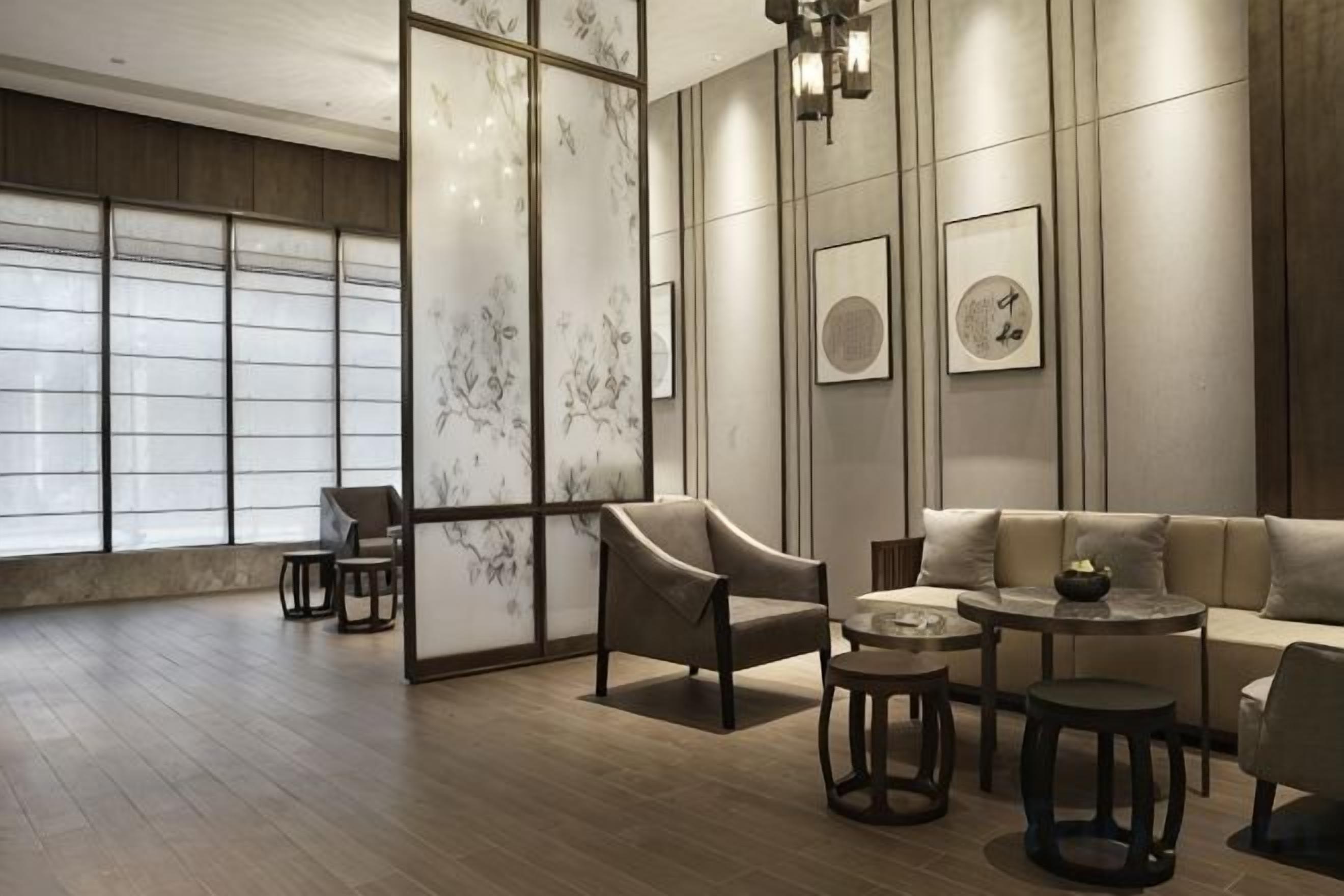 A modern interior with a sofa, armchairs, and a coffee table.