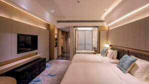 A hotel room with a TV, two beds, a bathroom, and a hallway. - Days Hotel Suites By Wyndham Zixin Changsha (Changsha)