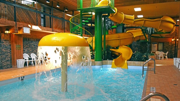 An indoor swimming pool with a water slide and a high platform. - Canad Inns Destination Centre Portage la Prairie (Portage La Prairie)