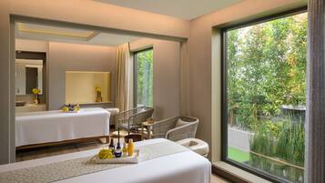 Enjoy a peaceful retreat with a garden view, comfortable seating area, and a well-appointed bed.