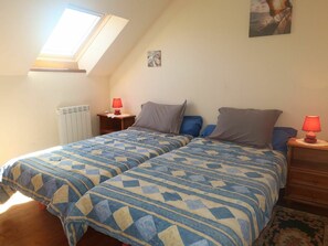 Relax in this serene bedroom with a large bed, two nightstands, and a small table.