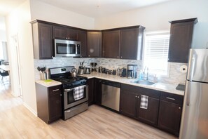 Fridge, microwave, oven, stovetop - North Center - Modern, Safe, Family-Friendly, Solar-Powered Apartment (Chicago)