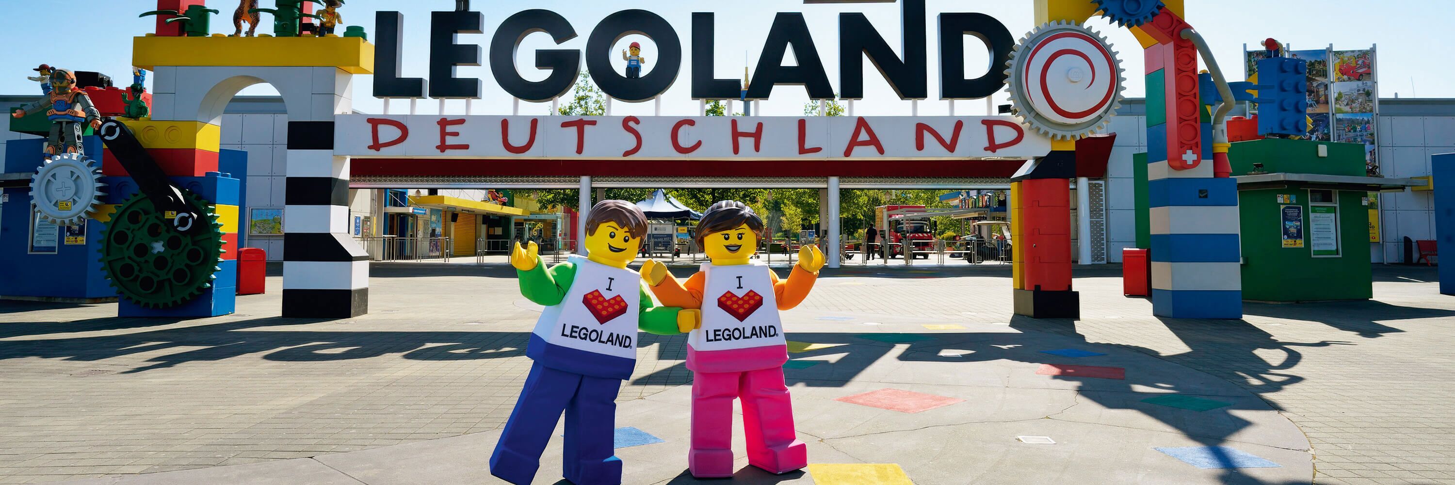 A LEGO-themed entrance with two LEGO figures, a large LEGO sign, and a colorful LEGO structure.