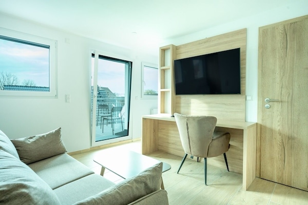 Deluxe Studio | Living area | Flat-screen TV, heated floors