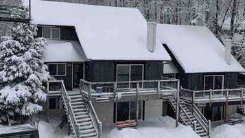 Stunning two-story lodge with a central entrance and two staircases leading to the upper level.