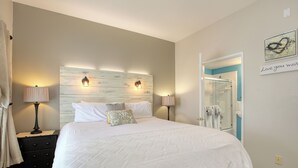 A neatly made bed with white linens, a wooden headboard, and two bedside lamps. - 210 Casa Bella: 2  BR, 2  BA Condominium in Pismo Beach, Sleeps 6 (Pismo Beach)