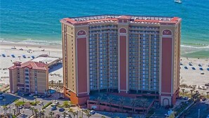 A large hotel with multiple floors, a beachside location, and a parking area. - Seawind 403: Updated, child friendly Beachfront, Best location in Gulf Shores (Gulf Shores)