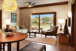 Relax in a cozy living space with a comfortable sofa, stylish armchair, and large window offering a view of the outdoors.