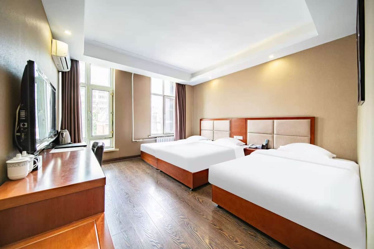 Deluxe Triple Room | Minibar, desk, laptop workspace, blackout drapes