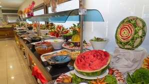 A buffet with various food items and a decorative watermelon centerpiece. - Grand Alisa Hotel – Ex.Royalisa Hotel (Alanya)