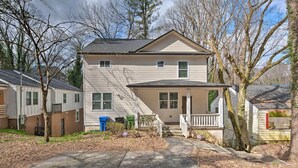 A two-story house with a front porch, a driveway, and a small shed in the backyard. - Chic Atlanta Home < 4 Mi to Mercedes-Benz Stadium! (Atlanta)