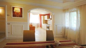A dining area with a red and beige striped tablecloth, two chairs, and a small table with a cup and saucer. - Great villa with pool, free wifi, beach, sea, last minute, Italy (Montelabbate)