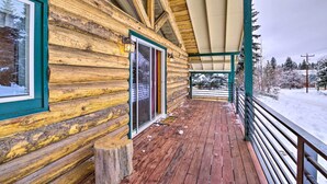 A log cabin with a wooden deck and a covered porch. - McCall Retreat w/ Hot Tub - 1/2 Mi to Downtown! (McCall)