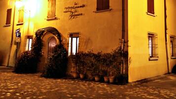 A building with a sign reading 'La Cantina del Borgo' at night.