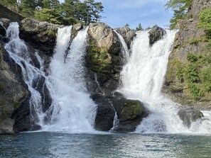A waterfall cascading over rocky terrain with clear water at the base. - Riverside Hostel B&B – Hostel (Katsuragi)