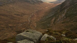 A mountainous landscape with a valley and a river. - The homely Mourne lodge (kilkeel)