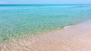 A beach with clear turquoise water and a sandy shore. - "Sea La Vie" | Gulf & Lakefront Views | Community Heated Pool | Tennis, Pickleball, Basketball (Panama City Beach)